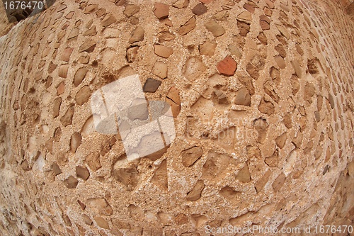 Image of Convex ancient stone wall texture shot with fisheye