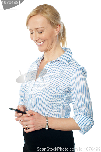 Image of Smiling young corporate lady messaging