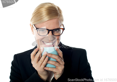 Image of Corporate woman enjoying coffee