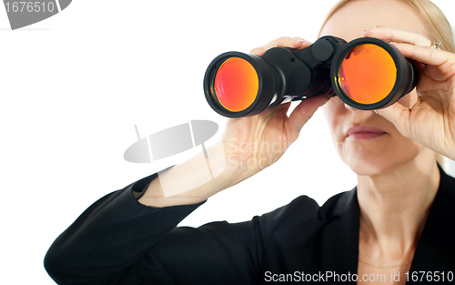 Image of Businesswoman looking through binoculars