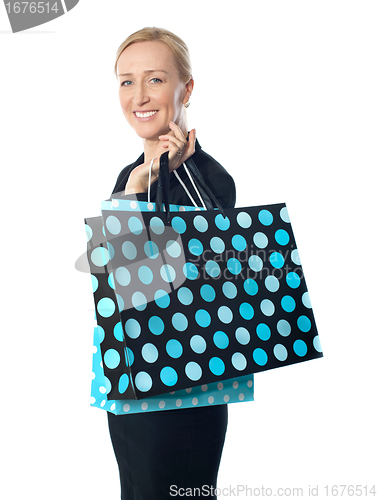 Image of Senior woman posing with dotted shopping bag