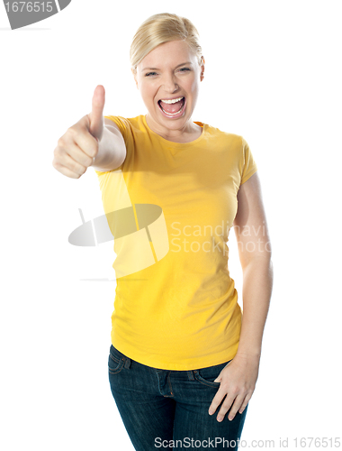 Image of Smiling gorgeous girl showing thumbs-up