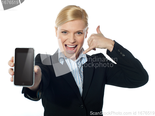 Image of Saleswoman displaying new iphone to camera