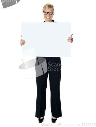 Image of Smiling young lady holding blank banner ad