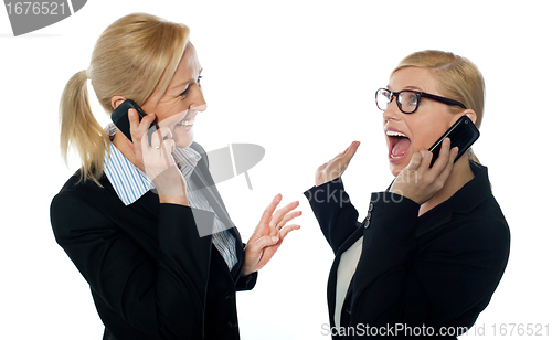 Image of Happy businesswomen communicating on cellphone