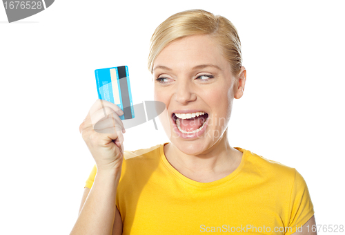 Image of Smiling young girl holding debit-card