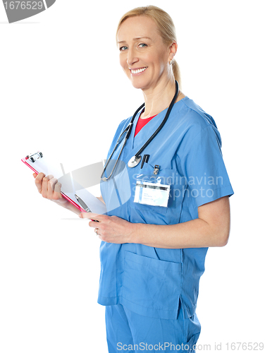 Image of Experienced female doctor with clipboard