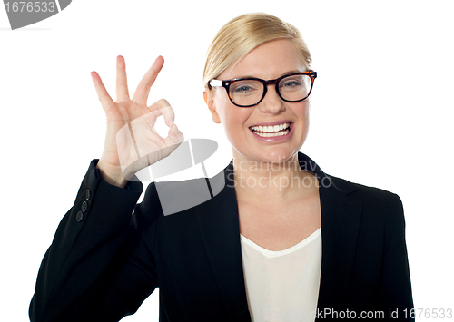 Image of Successful business woman posing with ok sign