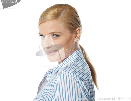 Image of Smiling young lady, turned half back