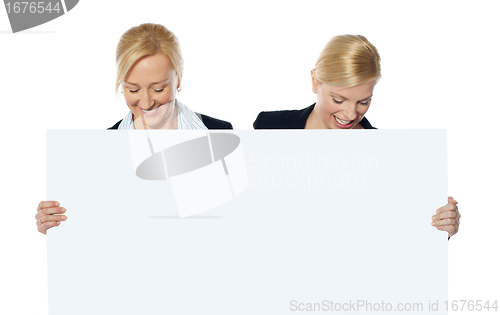 Image of Female business executives looking at blank banner ad