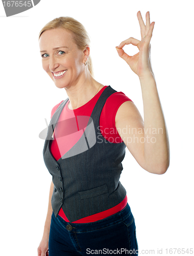 Image of Confident pretty woman gesturing excellent