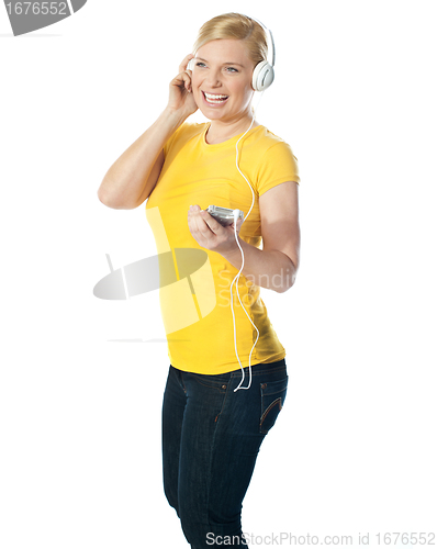 Image of Pretty woman holding music player
