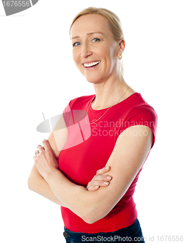 Image of Smiling middle aged lady, poisng with folded arms