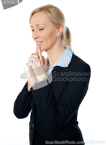 Image of Senior corporate woman posing with fingers on her lips