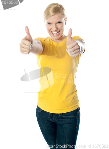 Image of Happy young woman showing double thumbs-up