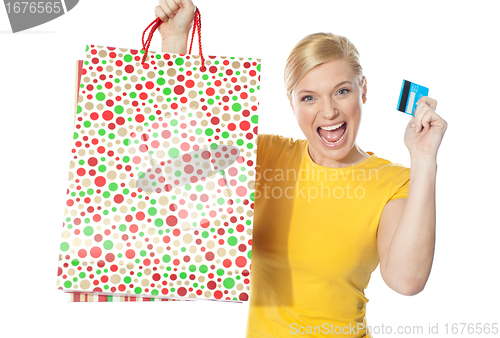 Image of Beautiful girl posing with shopping paper bag