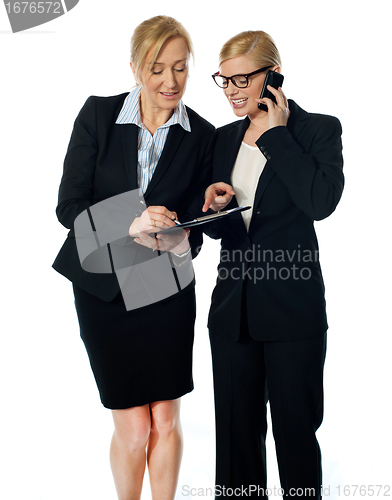 Image of Two females looking at progress report and discussing