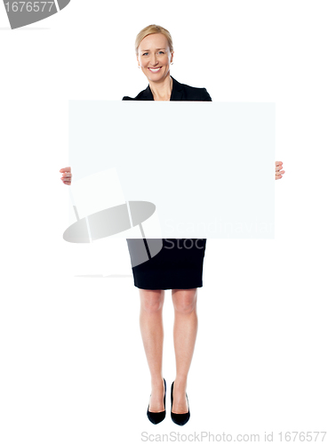 Image of Female business promoter holding white blank banner ad