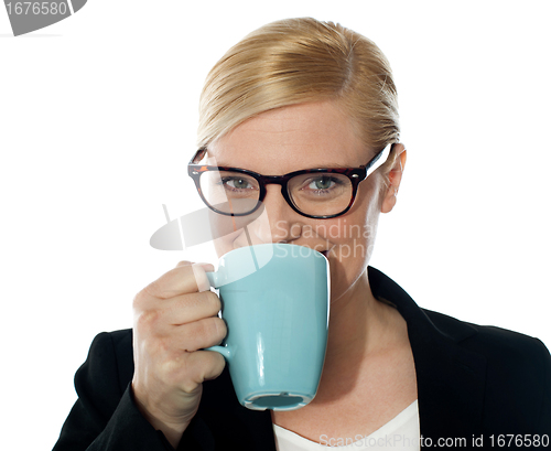 Image of Attractive corporate female drinking coffee