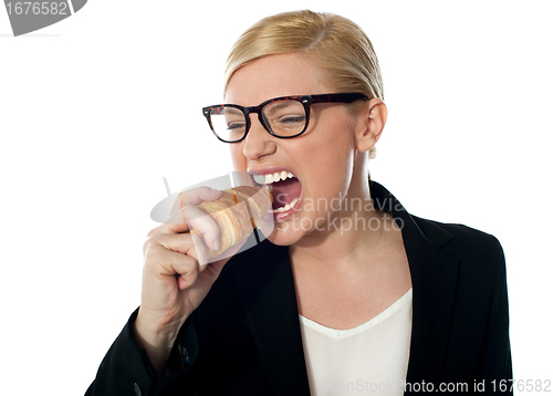 Image of Beautiful businesswoman eating