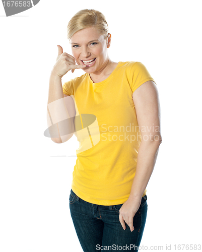 Image of Attractive girl showing calling gesture
