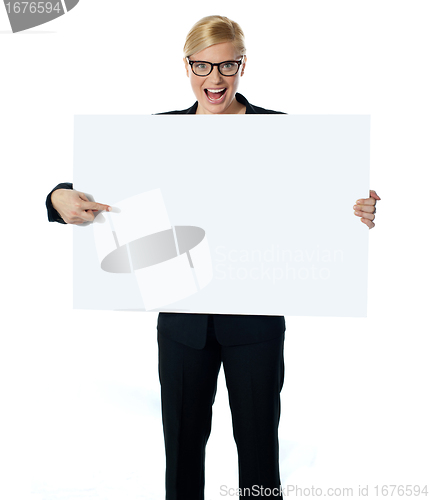 Image of Saleswoman pointing at blank billboard