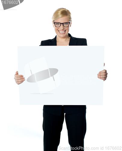 Image of Attractive businesswoman holding blank advertising board