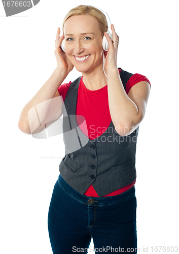 Image of Aged female enjoying music on her music player