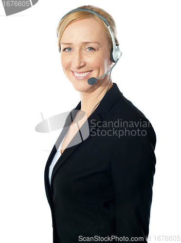 Image of Aged female call centre excutive posing with headsets