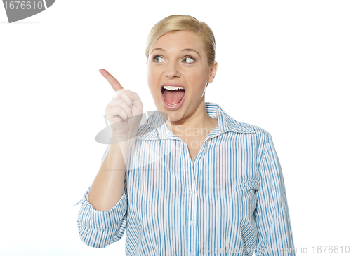 Image of Excited female business executive pointing away