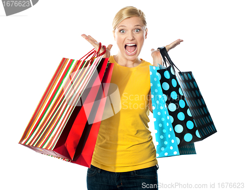 Image of Young woman excited after tons of shopping