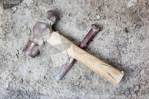 Image of Grungy hammer and chisel
