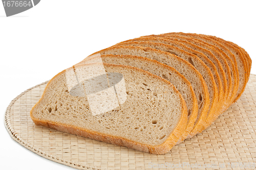 Image of Fresh bread sliced on a place mats isolated on white 