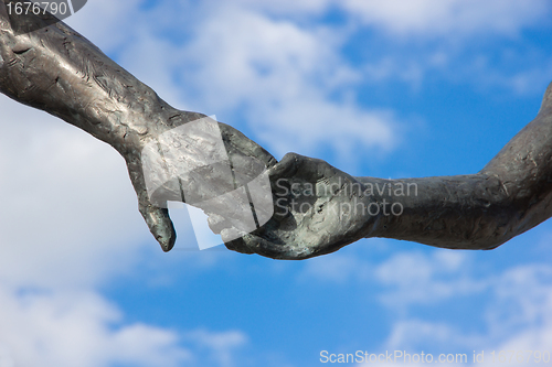 Image of hand holding statues