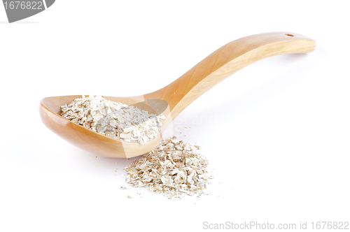 Image of Oat meal cereal mixed in wooden spoon 