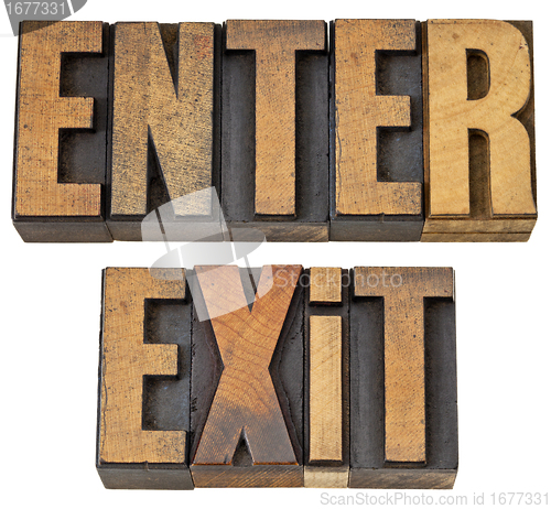 Image of enter and exit words in wood type