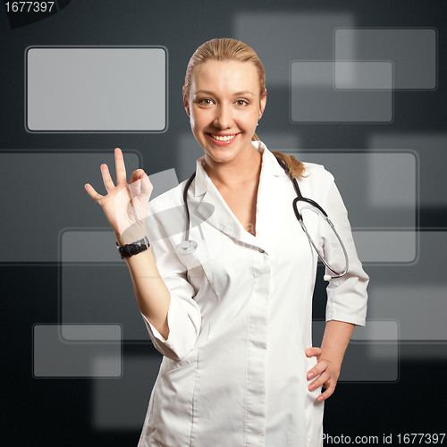 Image of young doctor woman shows ok