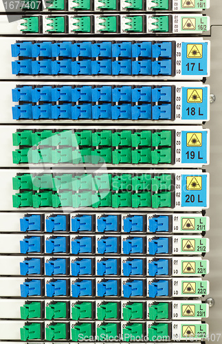 Image of fiber optic rack with high density of blue and green SC connectors