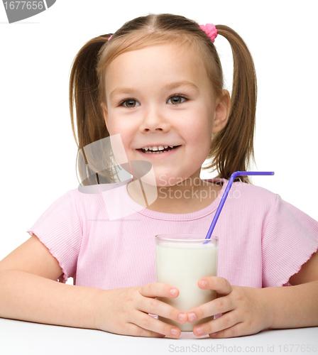 Image of Cute little girl with a glass of milk