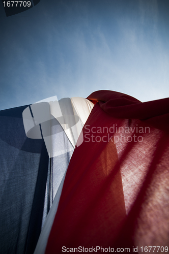 Image of Dutch wrinkled flag against sun