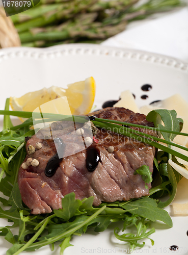 Image of Beef on arugula salad and parmesan