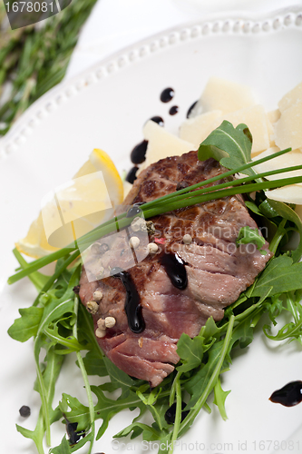 Image of Beef on arugula salad and parmesan