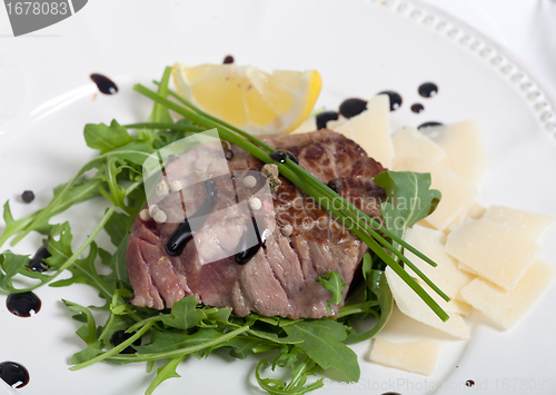 Image of Beef on arugula salad and parmesan
