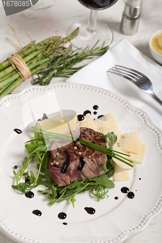 Image of Beef on arugula salad and parmesan