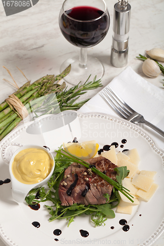 Image of Beef on arugula salad and parmesan