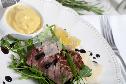 Image of Beef on arugula salad and parmesan