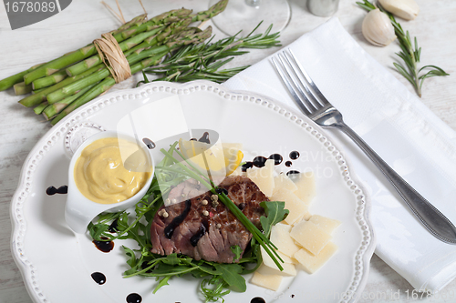 Image of Beef on arugula salad and parmesan