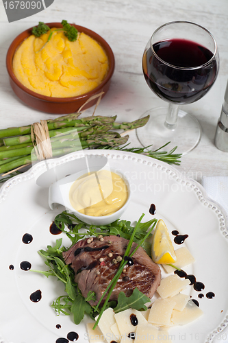 Image of Beef on arugula salad and parmesan