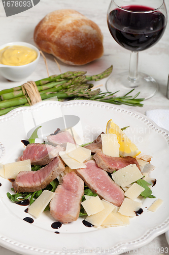 Image of Beef on arugula salad and parmesan