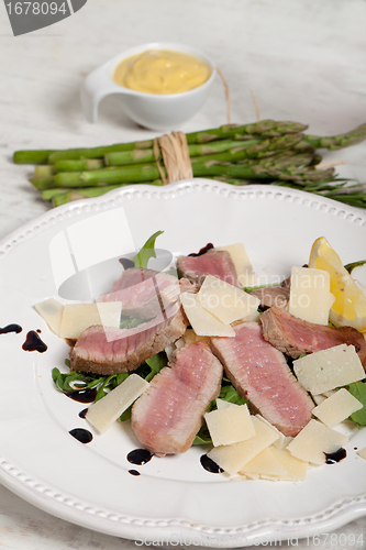 Image of Beef on arugula salad and parmesan